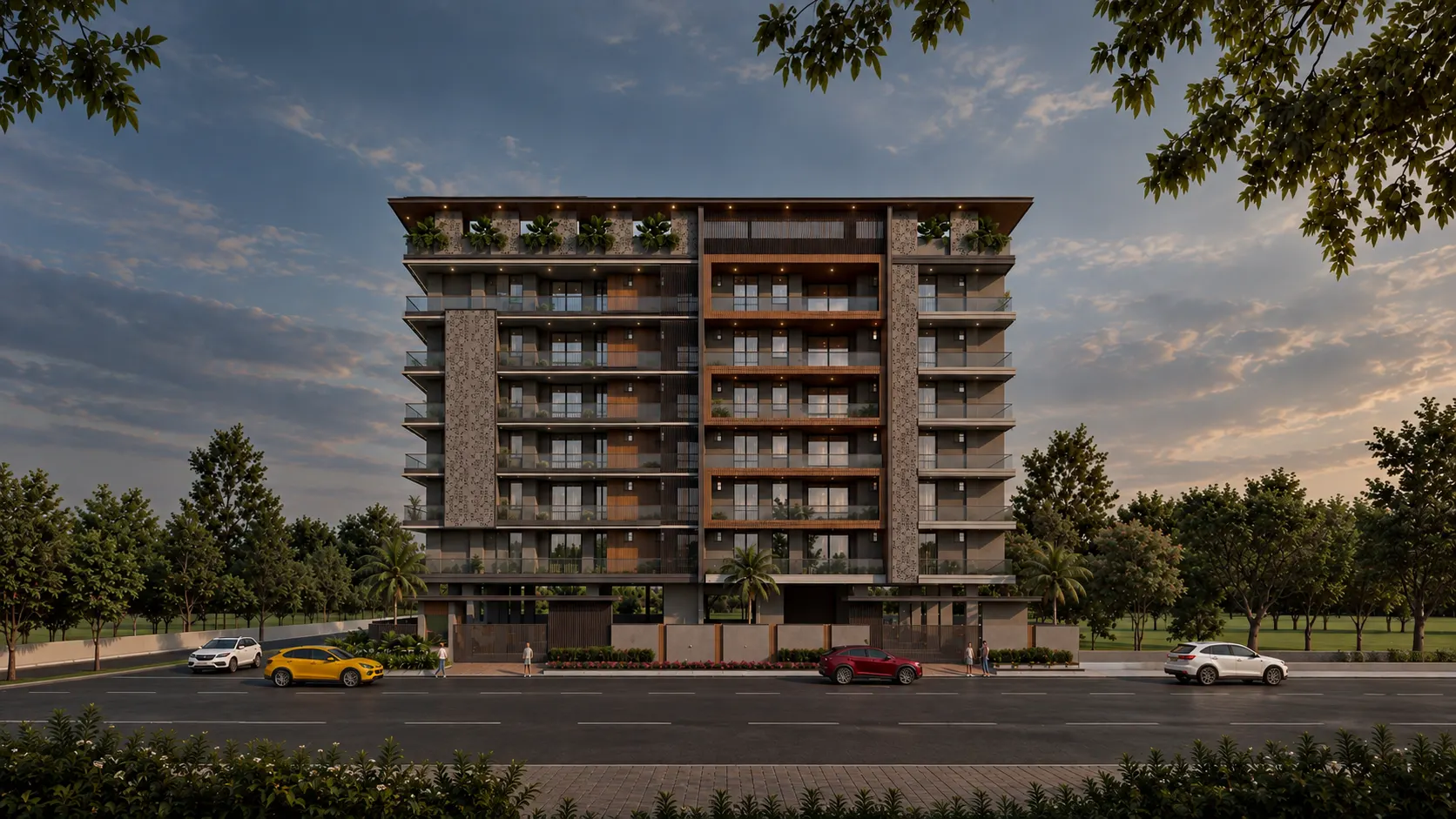 Vaishali Suites at dusk: stone, teak and jaali screens rising above a planted entrance in Vaishali Nagar.