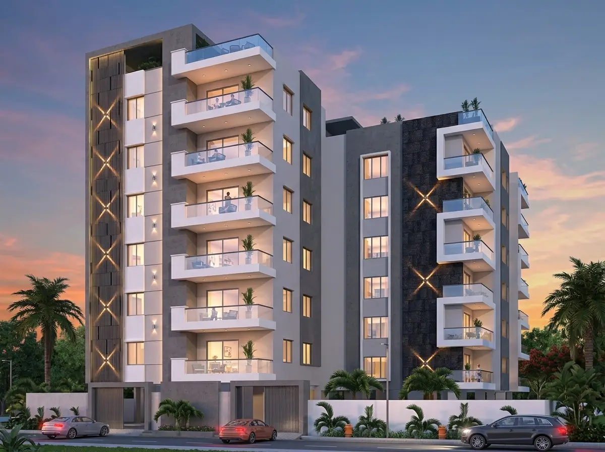 Two apartment towers with a geometric facade at sunset.