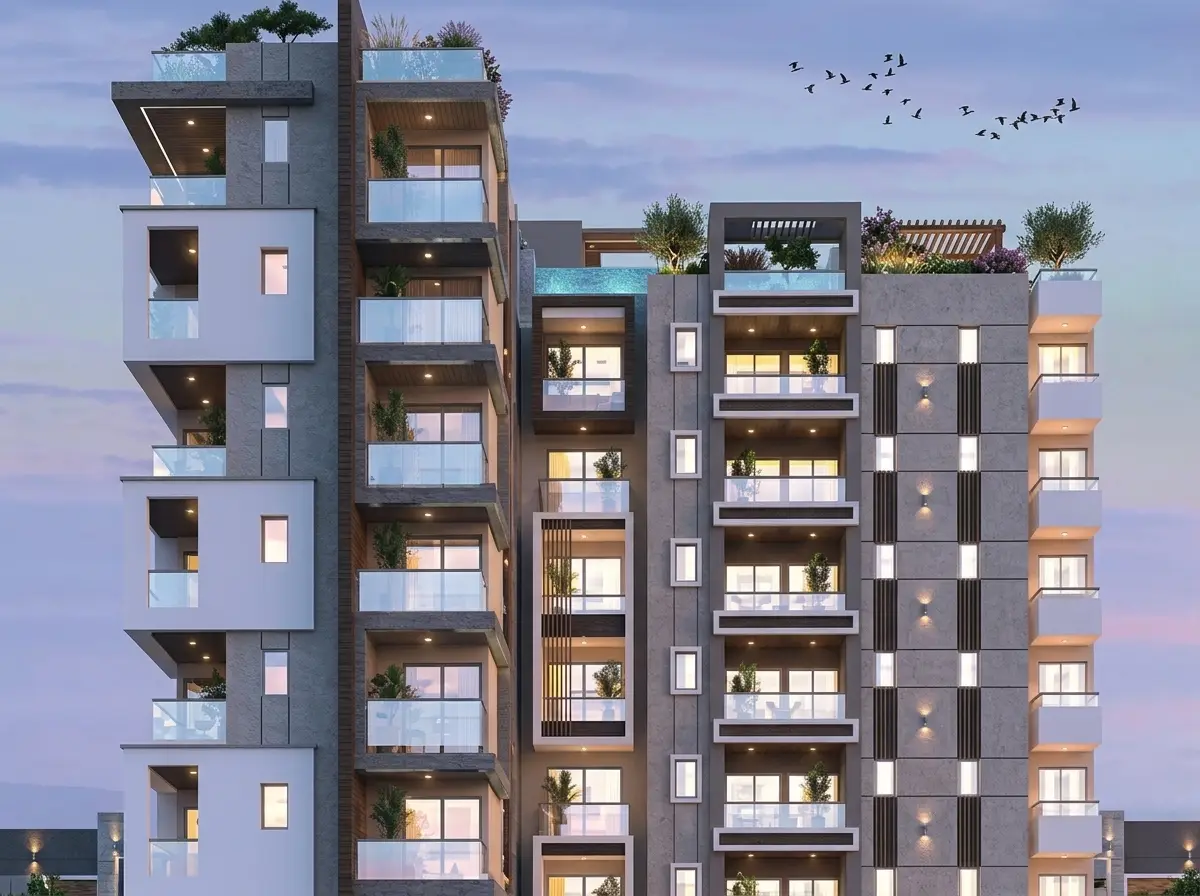 A residential building with a rooftop garden terrace at dusk.